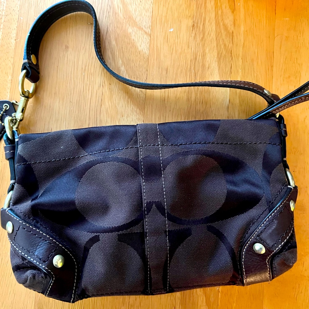Coach dark brown purse with gold accents in great condition. No marks or tears.